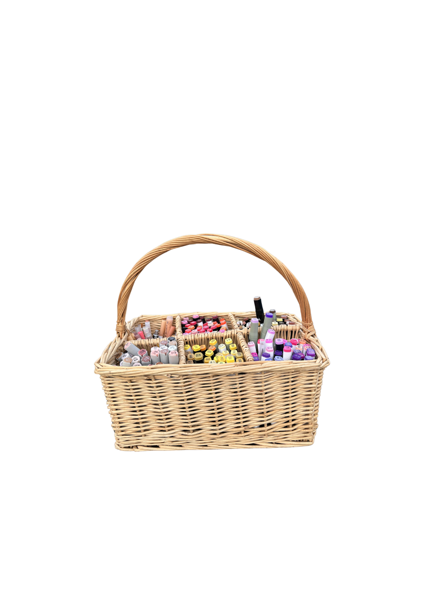 Faith's wicker basket filled with coloured markers, pens, and illustration supplies
